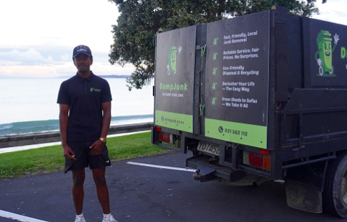 DumpJunk crew member standing by the truck at the coast