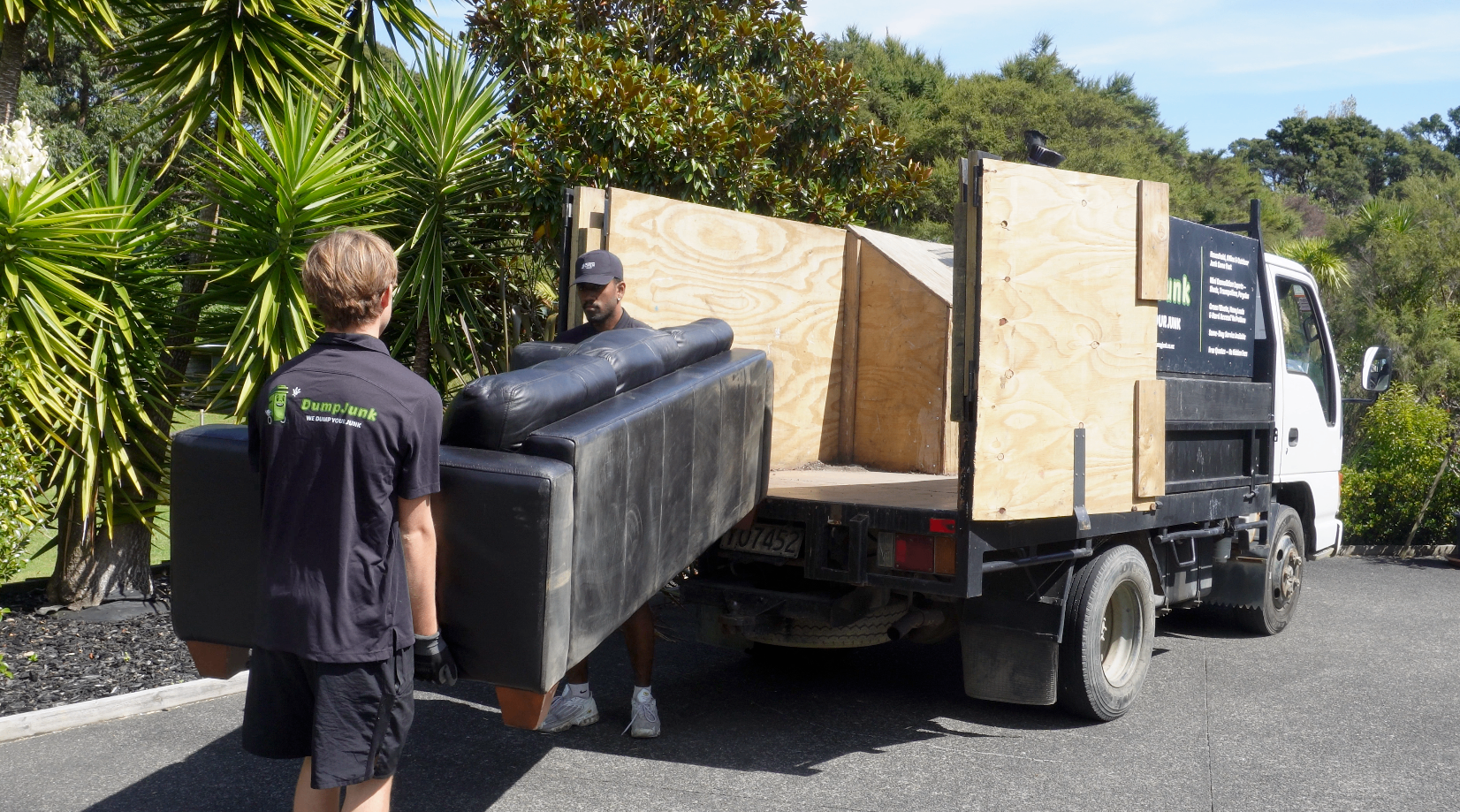 DumpJunk crew loading a couch onto the truck